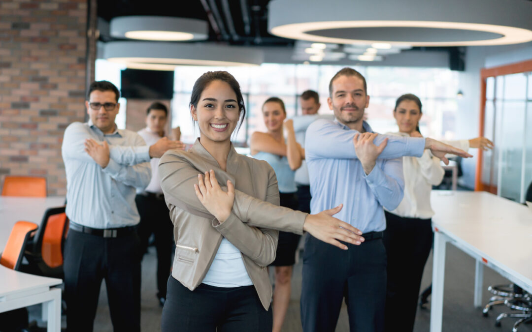 Business people stretching while participating in workplace wellness program